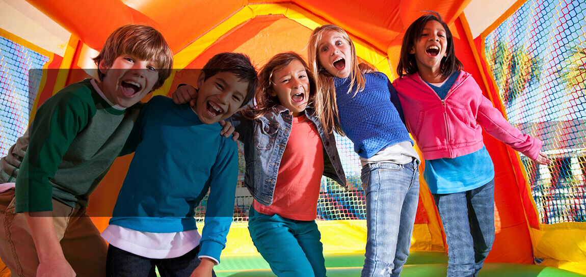 kids laughing and having fun on a bouncy house inflatable castle